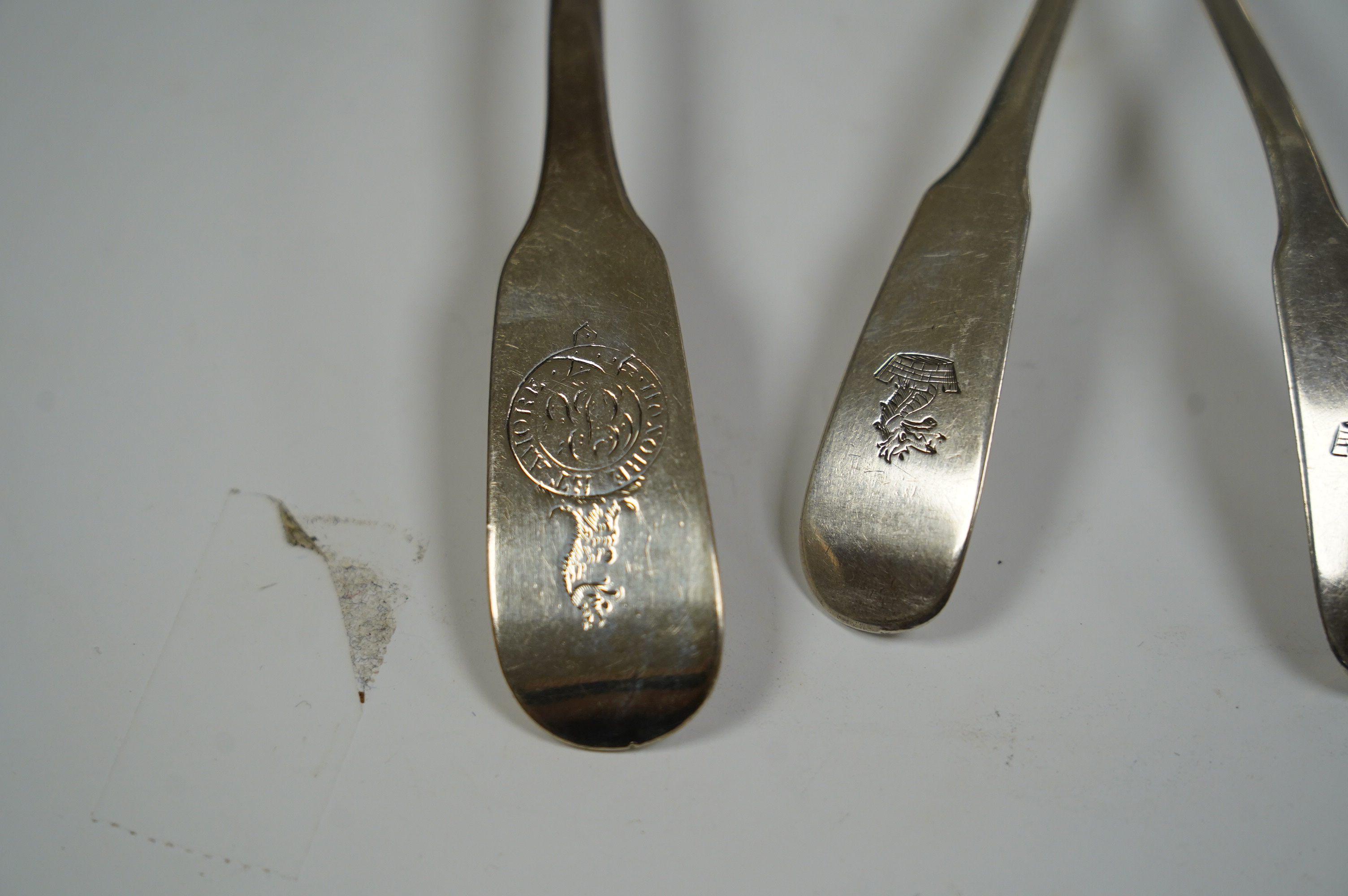 A pair of George IV Scottish silver fiddle pattern sauce ladles, Andrew Wilkie, Edinburgh, 1824, 15.2cm, together with a similar Irish pair by Richard Garde and another maker's mark RT, Dublin, 1823, 4.7oz. Condition - f